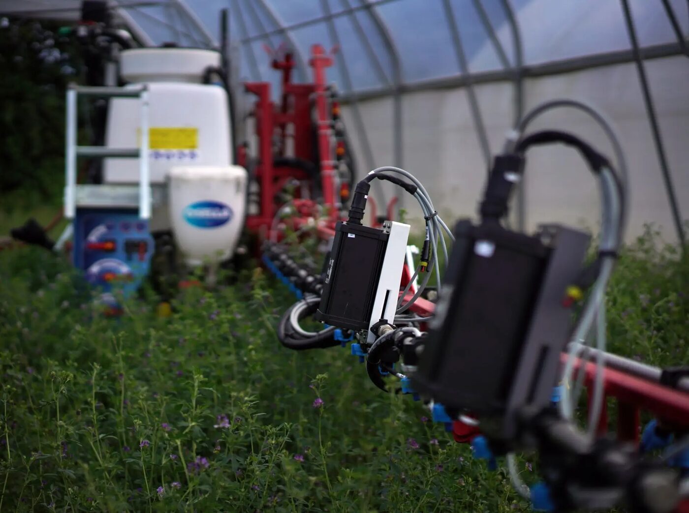 An Open Weed Locator unit mounted on a field robot's spray boom in a crop field
